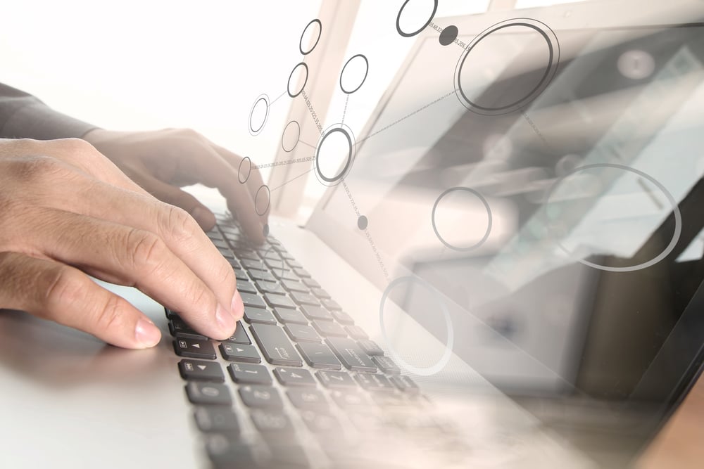 Close up of business man hand working on laptop computer with social media diagram and chart graph on wooden desk as concept